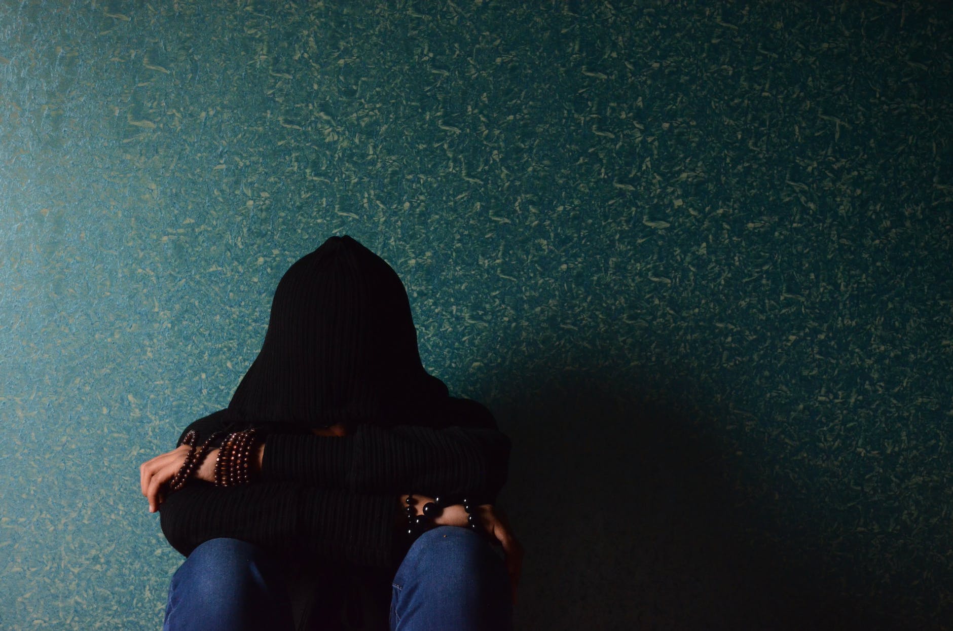 woman sitting near wall